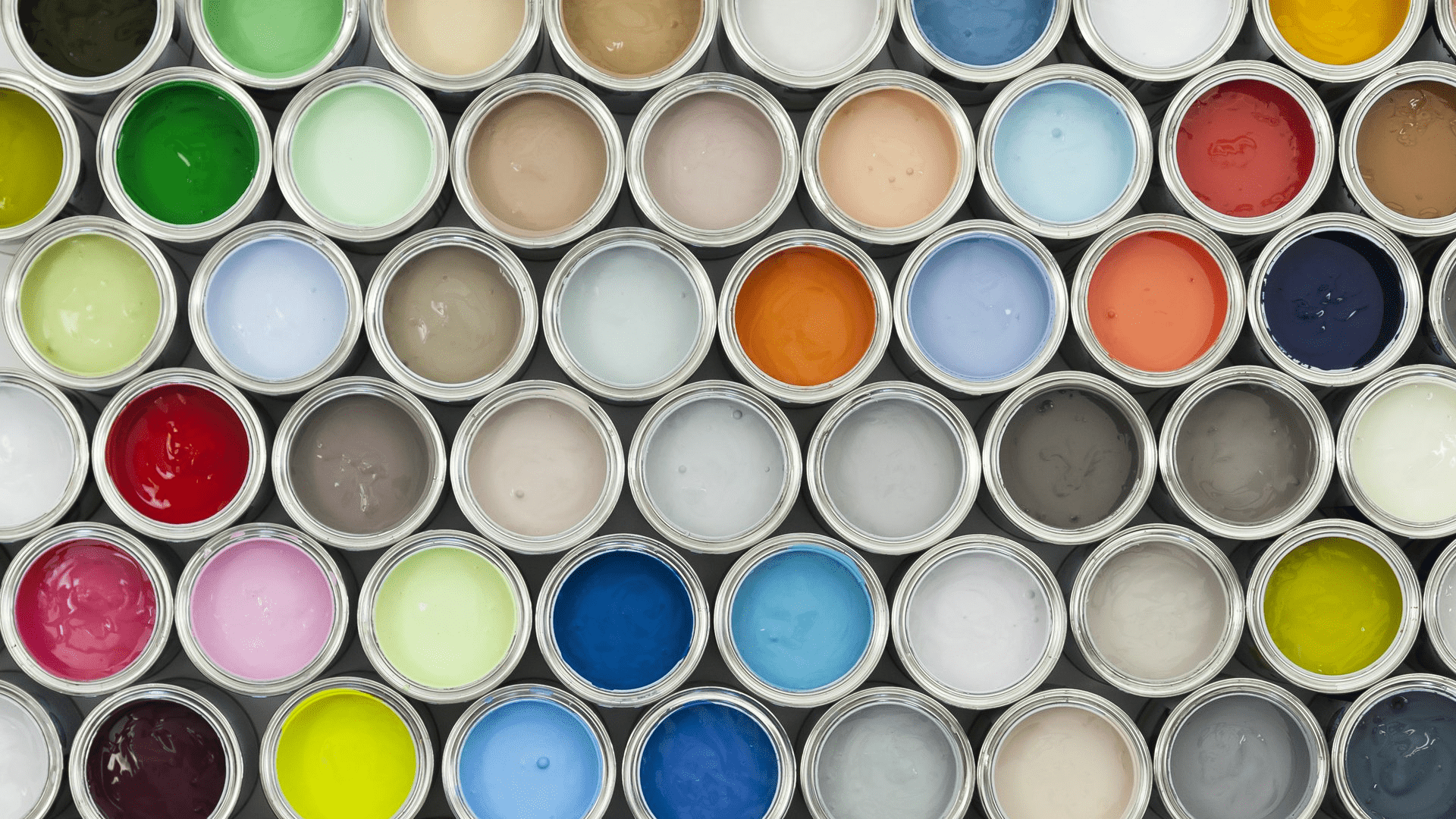 A bunch of paint cans are all painted different colors