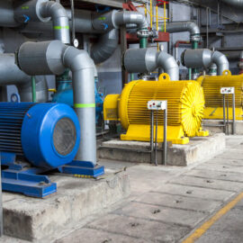 A group of industrial pumps sitting next to each other.