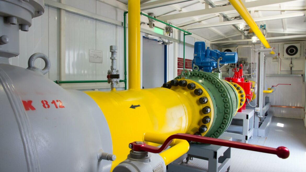 A yellow and green pipe system in a factory.