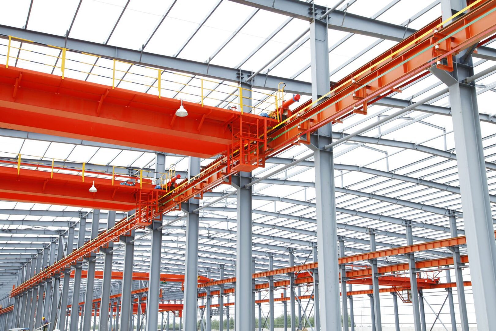 A large metal structure with orange equipment on it.